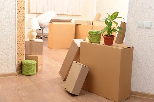 Professional movers loading furniture into a van in Merton