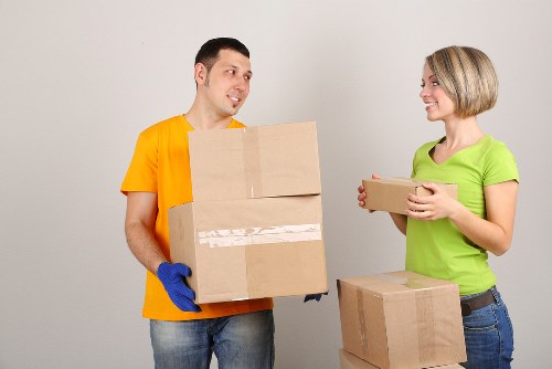Movers unpacking household items in a Merton property