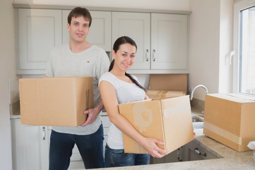 Loading furniture into a moving truck for a residential relocation in Merton